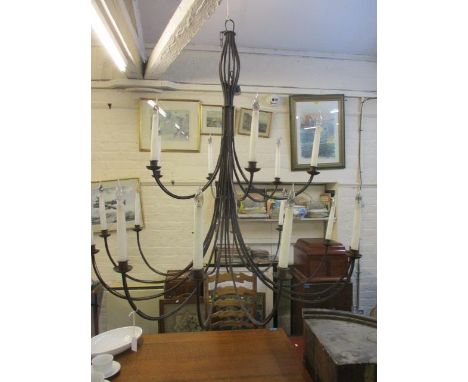 A barn-inspired metal 18-arm candelabra style ceiling light 47" x 47" 