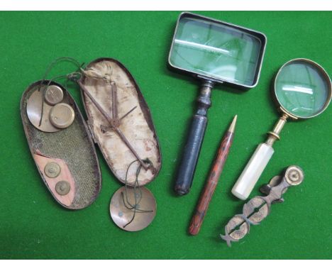 A set of sovereign and half sovereign scales and a set of travel scales, two magnifying glasses and a pencil 
