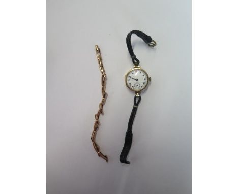 A 9ct manual wind wristwatch on a leather strap - running, some cracks to dial - and a 9ct sprung watch strap - total weight 