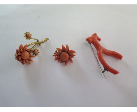 Three coral brooches, two in floral form and one stick coral brooch in wishbone form - all on base metal fittings - Italian o