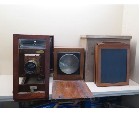 A Lancaster mahogany full plate 25cm x 30cm bellows camera and sliding magnifier with three spare plates in a carry case plat