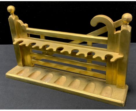 An early 20th century cast brass novelty pipe rack, as a five-bar gate 
