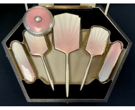 A Walker &amp; Hall Art Deco enamelled five piece dressing table set, in pale pink and creamy white tones, Chester 1939, engi