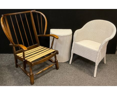 An Ercol style wingback armchair, 88cm high x 76.5cm wide;  Lloyd loom bedroom chair and laundry basket, (3). 