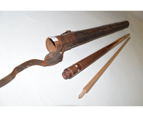 A vintage Hiolle two-piece pool cue with textured grip and inlaid mother of pearl detail with an accompanying vintage leather