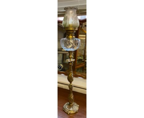 Antique ornate brass and glass paraffin lamp. Comes with an acid etched art nouveau shade. 83cm in height 