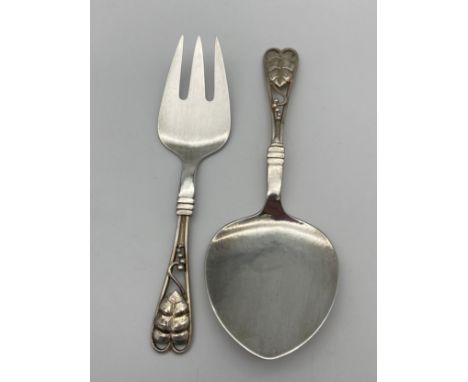 A Danish Georg Jensen silver serving fork and slide set. Design with leaf and berry final design. [17.5cm in length] 