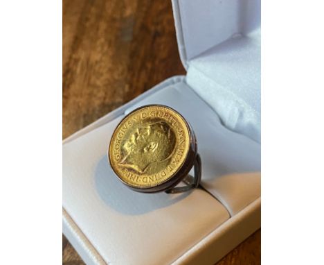 A Gold George V 1913 Half soveriegn coin fitted within a 9ct gold ring. [Ring size K] [7.77Grams] 