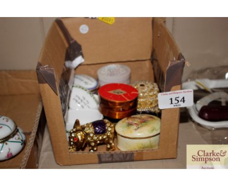 A collection of various porcelain and other lidded patch boxes 