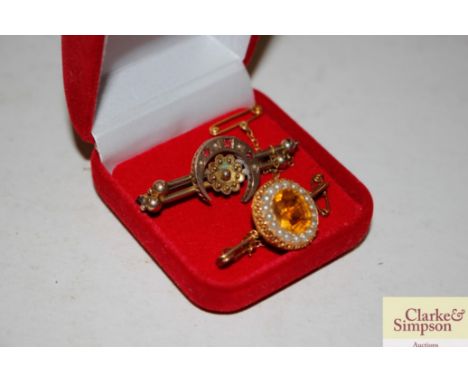 A citrine type and sea pearl set bar brooch; and another bar brooch of crescent form inset garnets and sea pearls 