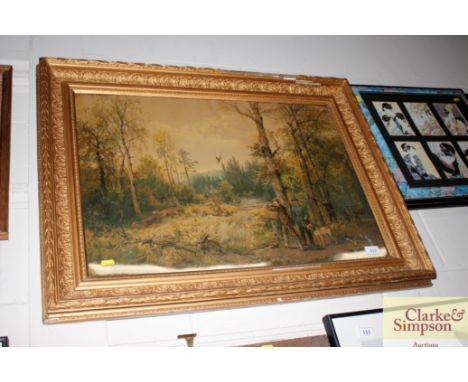 A gilt framed print depicting a hunting scene