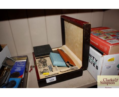 A leather jewellery box and contents of various brooches, compact, clip-on ear-rings 