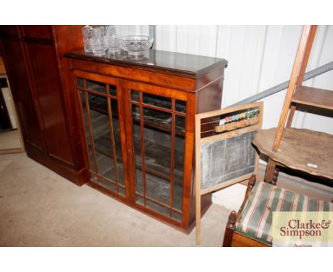 A 19th Century walnut and box strung bookcase, the adjustable shelves enclosed by a pair of glazed panel doors