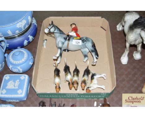 An ornament in the form of a hunting figure and five hounds  AF