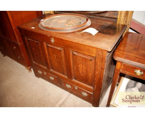 An 18th Century oak coffer having inlaid triple panel front and two drawers below