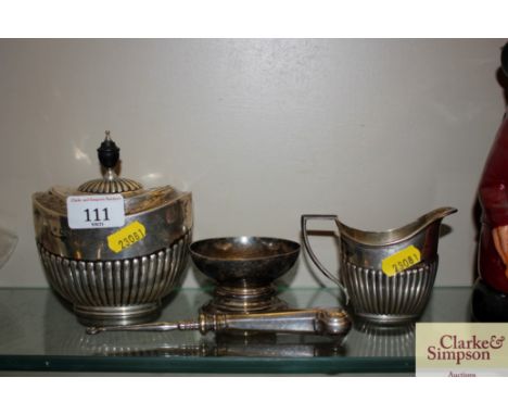 A silver tea caddy; and a silver handled button hook, jug and bowl