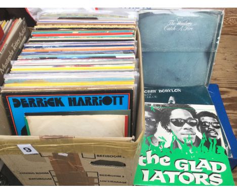 A box of reggae and ska LPs and 12inch singles by various artists including an original Wailers 'Catch A Fire' LP in zippo sl