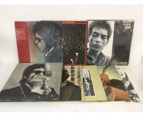 Two bags of 17 Bob Dylan and related LPs and a 3 cassette 'Bootleg Series Volumes 1-3' box set.