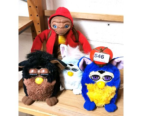 Three vintage Furby toys and an E. T. toy.