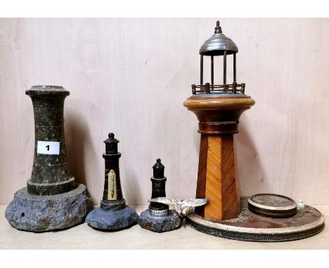 Three Cornish granite lighthouses, tallest H. 23cm and a vintage lighthouse table lamp, H. 33cm.