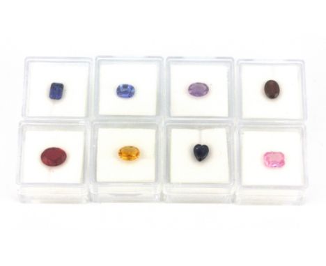 Eight individually boxed unmounted gemstones, including sapphire, pink sapphire, amethyst, etc..