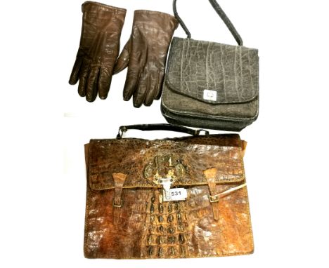 A vintage crocodile skin briefcase, together with a 1920's elephant hide bag and a pair of leather gloves.