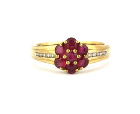 A 9ct yellow gold ruby set cluster ring with diamond set shoulders, (N).