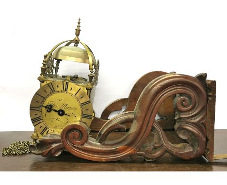 A brass reproduction clock with a mahogany wall bracket, clock H. 38cm.