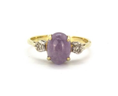 A 9ct yellow gold ring set with cabochon cut lavender jade and brilliant cut diamonds, (M).