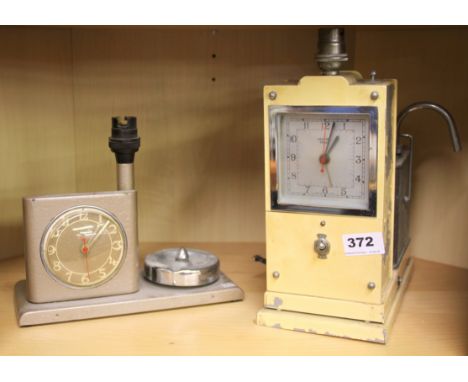 An early Hawkins teasmade clock and a smoker's stand clock and lamp.