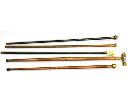 A Victorian ivory topped cane, a silver topped cane and three others, one with telescope another with compass.