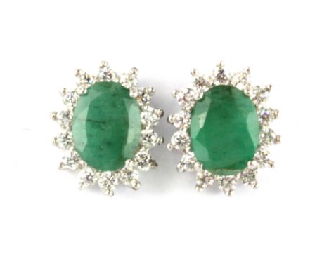 A pair of 925 silver cluster stud earrings set with oval cut emeralds and cubic zirconia, L. 1.2cm.