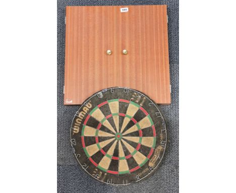 Two vintage dartboards, one unused.