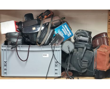 A quantity of mixed vintage cameras and tripods.