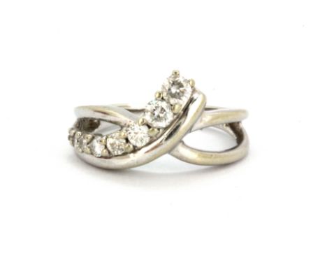 A 10ct white gold (stamped 10k) ring set with graduated brilliant cut diamonds (K.5).
