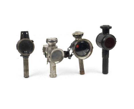 Four candle-powered early cycle lamps,comprising Lucas 'Candle Lamp'; Saint Etienne 'MF'; and two others (one lacking chimney