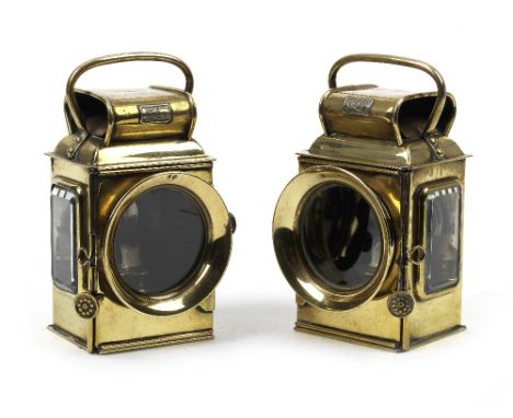 A good pair of 'Camelinal' oil-illuminating side-lamps,polished brass squared bodies, with 3-inch clear main lenses, bevelled