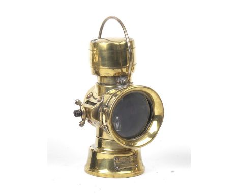 A Lucas No.631 oil-illuminating number plate lamp,polished brass body with electric conversion to rear, 2¾ inch clear main le