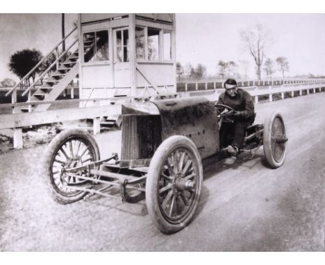 A photograph of Barney Oldfield in the Peerless Green Dragon, circa 1905,depicting the 'Speed King' at the wheel with tradema