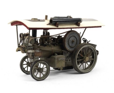 A live steam engineer's model of a Showman's Road Locomotive Traction Engine,machined but unpainted, showman's type, with can