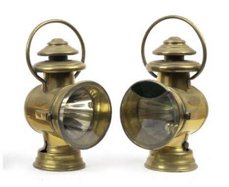 A pair of Ducellier oil-illuminating side-lamps, French,brass bodies, with 5¾ inch clear bevelled lenses, the left side lamp,