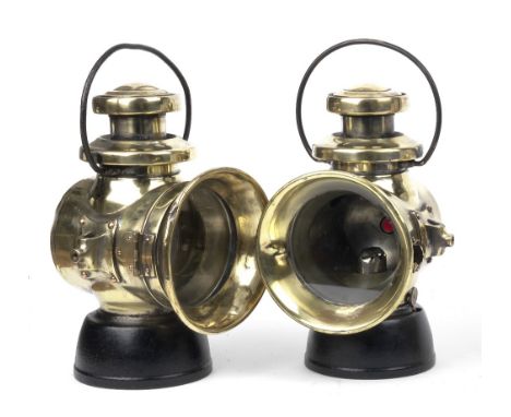 A pair of Lucas No.742 oil-illuminating side-lamps,polished brass bodies, with black painted reservoirs, 4¾ inch clear lenses
