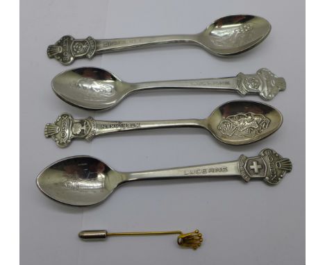 Four Rolex spoons and a Rolex stick pin 