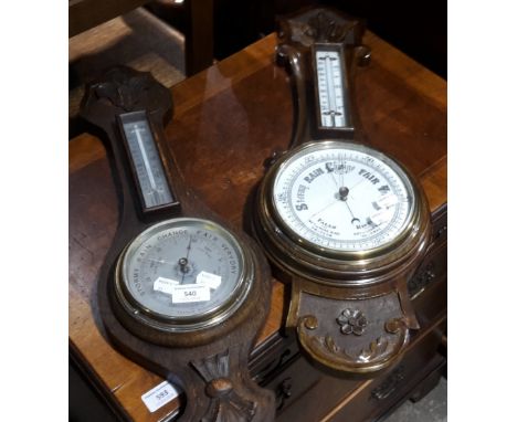 An oak framed barometer and another