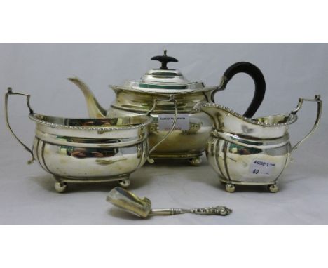 A silver three piece tea set and a caddy spoon