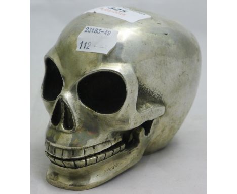 A silver plated model of a skull