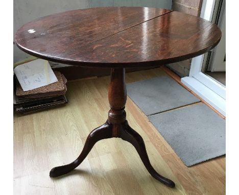 A George III oak tilt top tripod table