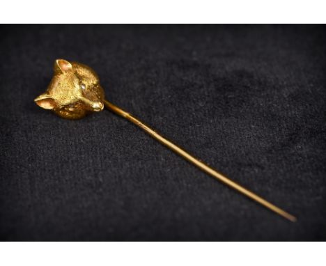 An unmarked gold and diamond stick pinThe top formed as a fox mask with diamond inset eyes.  5 cm long. 