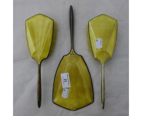 A three piece silver and enamel dressing table set