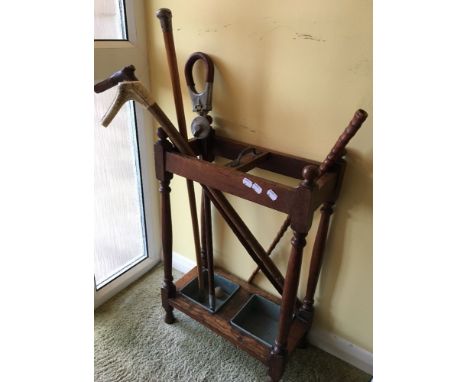 A Victorian oak stick stand and sticks